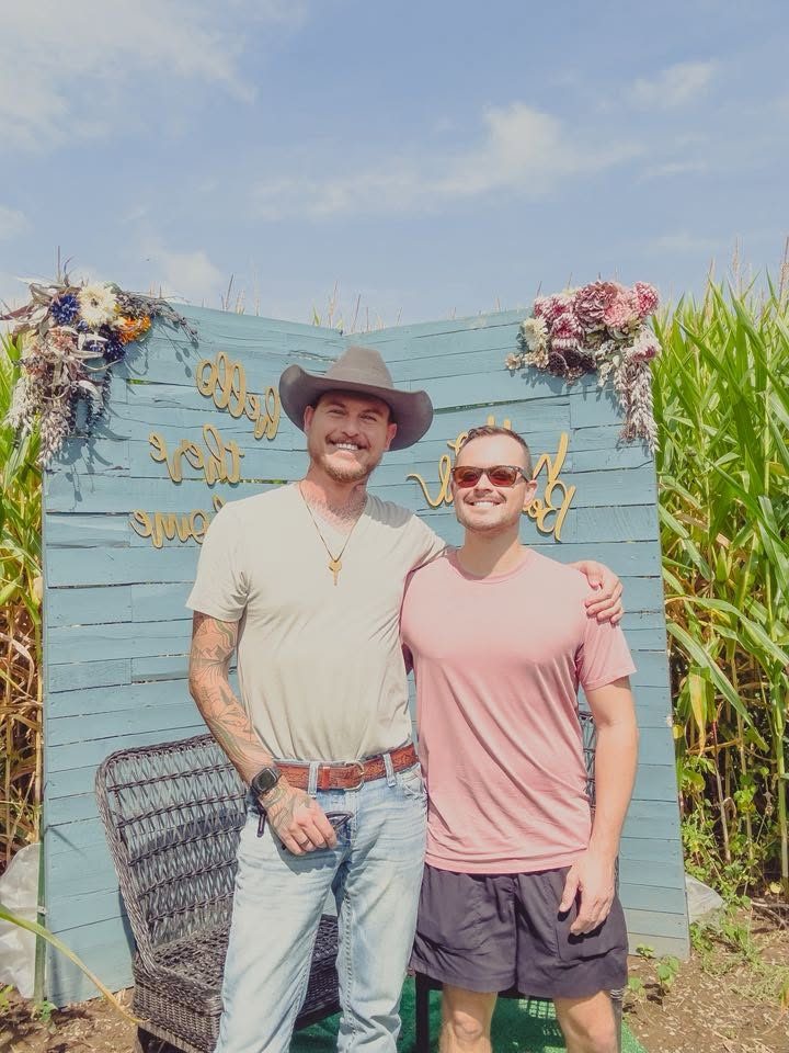 Shawn and his husband in a corn maze