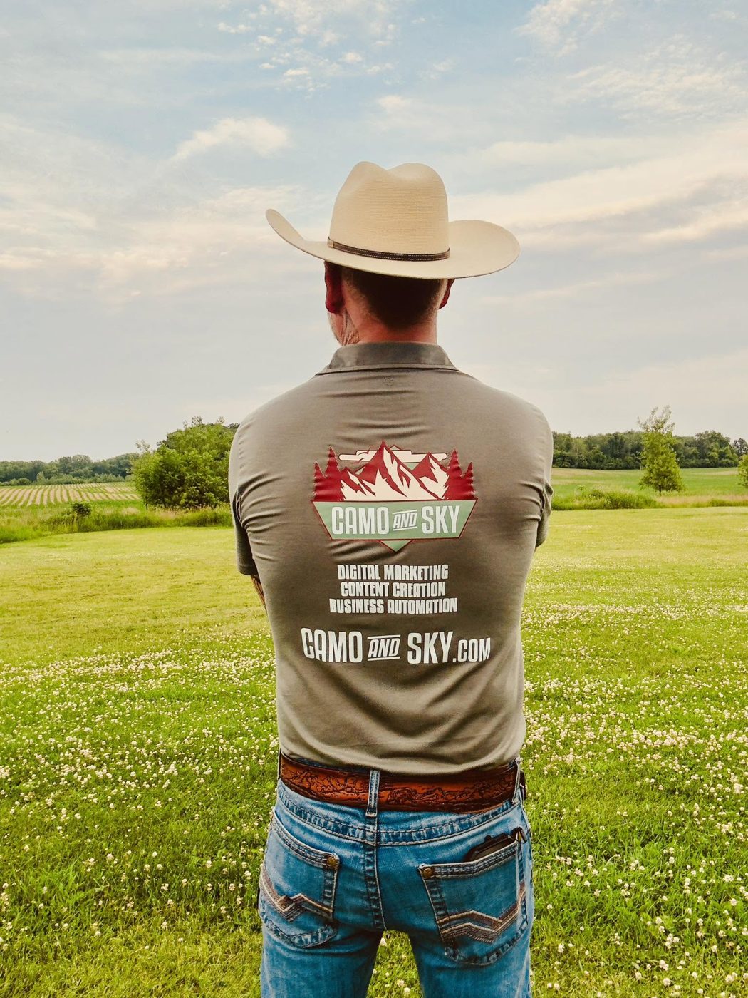 Shawn in a Camo and Sky shirt looking out over a field