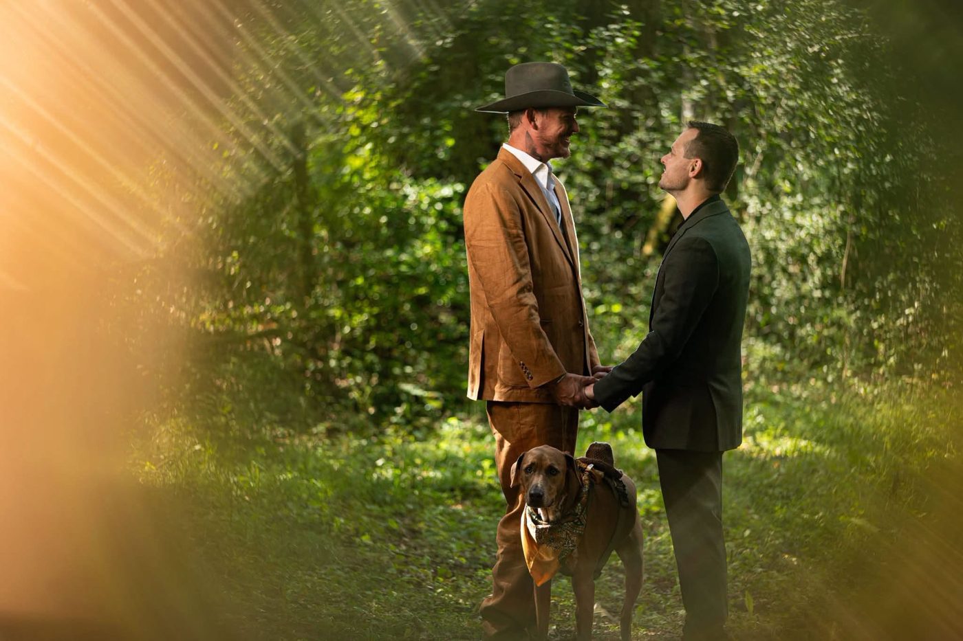 Shawn and his husband with their dog on their wedding day